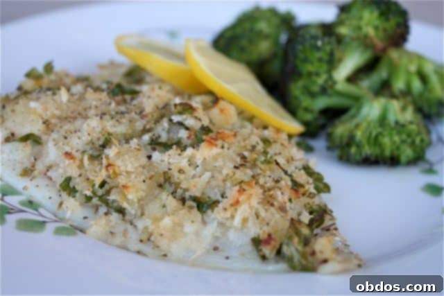 breaded and herbed fish on a plate with lemon