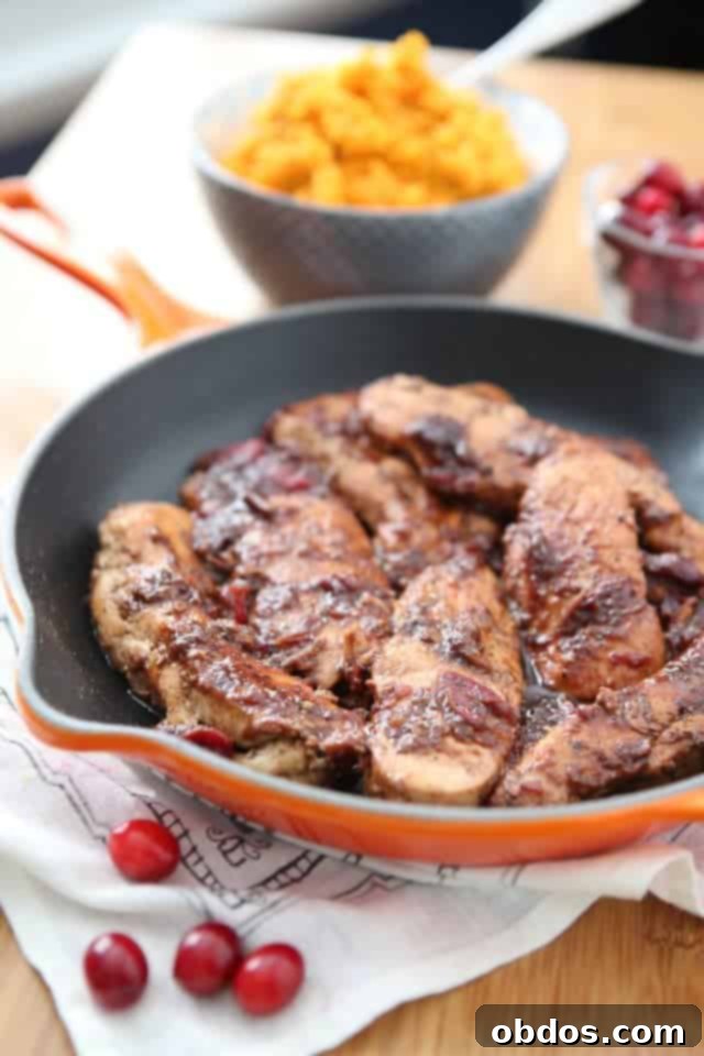 skillet of chicken topped with cranberry balsamic dressing