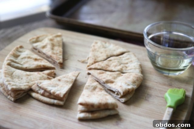 pita bread cut into triangles on a cutting board