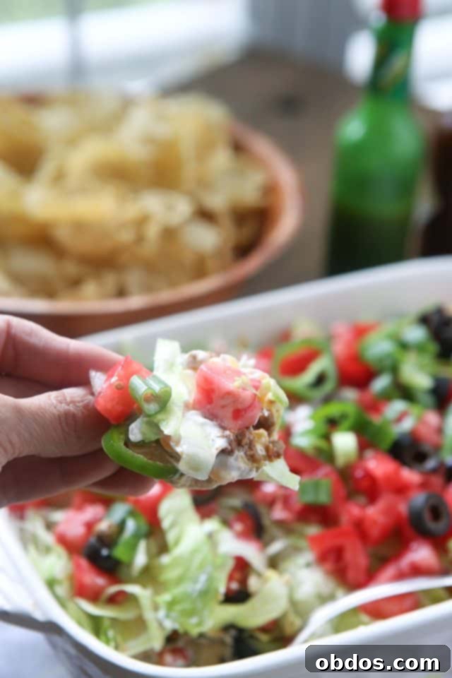 Μια λαχταριστή, πολυσύνθετη Taco Dip με στρώσεις γεύσεων, ιδανική για πάρτι και συγκεντρώσεις.