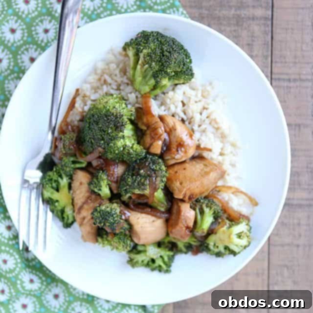 λευκό πιάτο με stir fry κοτόπουλο και μπρόκολο πάνω από καστανό ρύζι